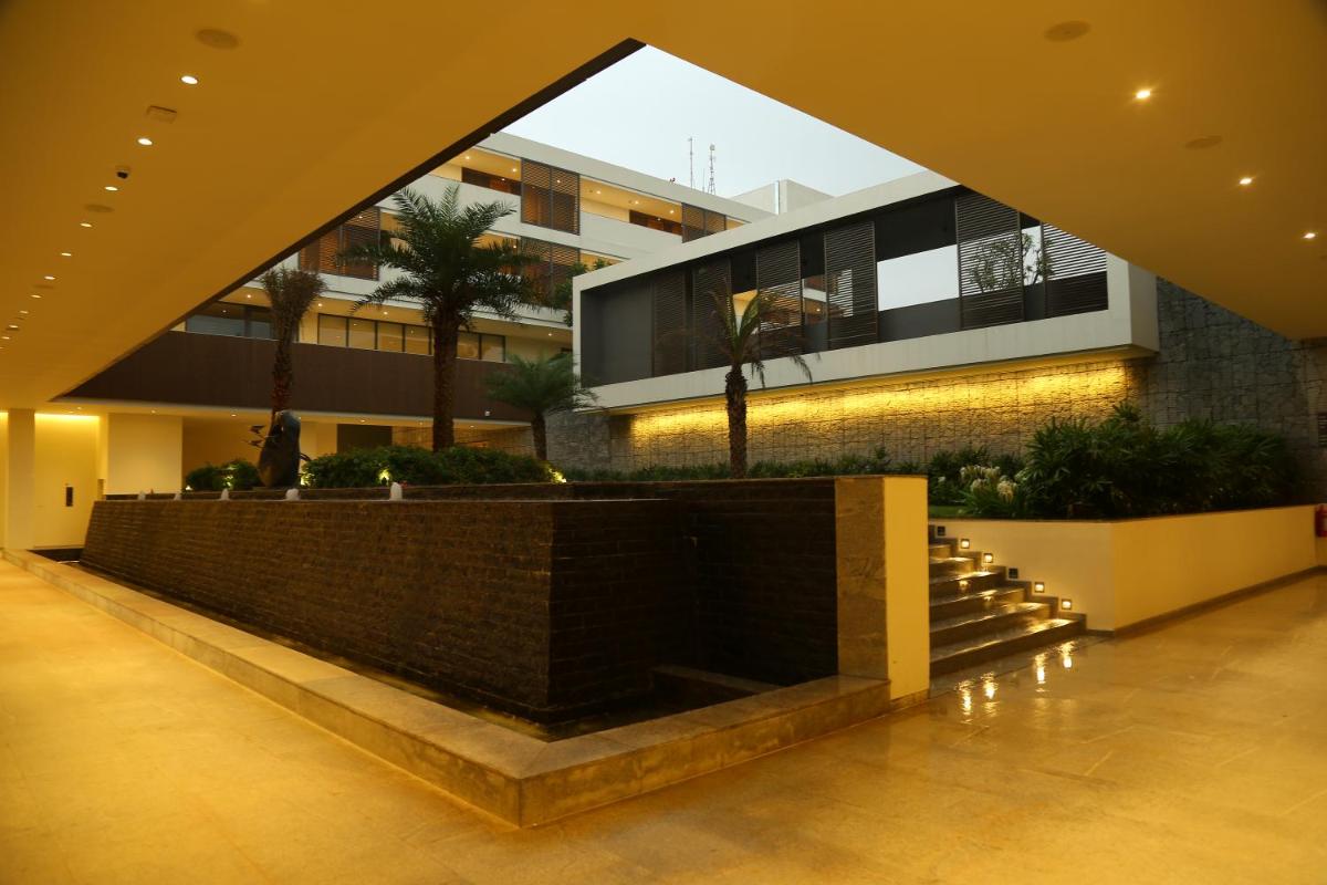 a building with a staircase in front of a building at BLVD Club - Near BENGALURU AIRPORT in Bengaluru
