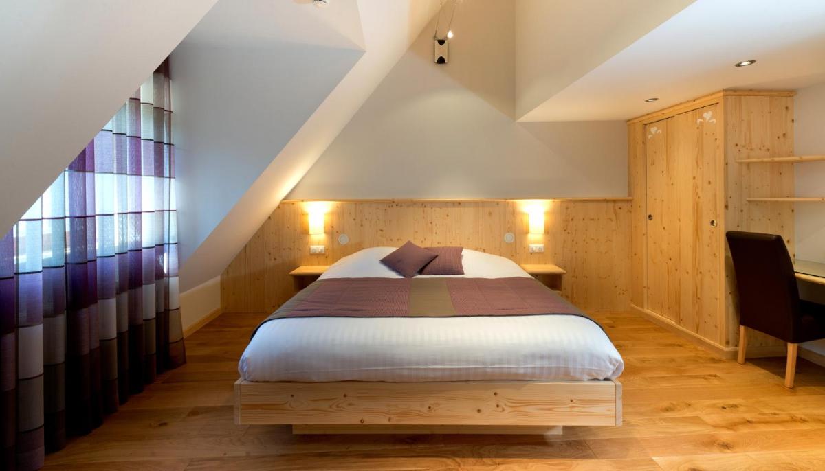 Un ou plusieurs lits dans un hébergement de l'établissement LE CLOS DES SOURCES Hôtel & Spa