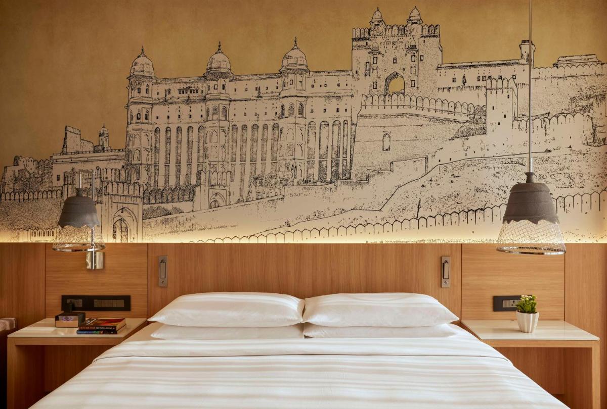 a bedroom with a drawing of a castle on the wall at Hyatt Place Jaipur Malviya Nagar in Jaipur a bedroom with a drawing of a castle on the wall at Hyatt Place Jaipur Malviya Nagar in Jaipur
