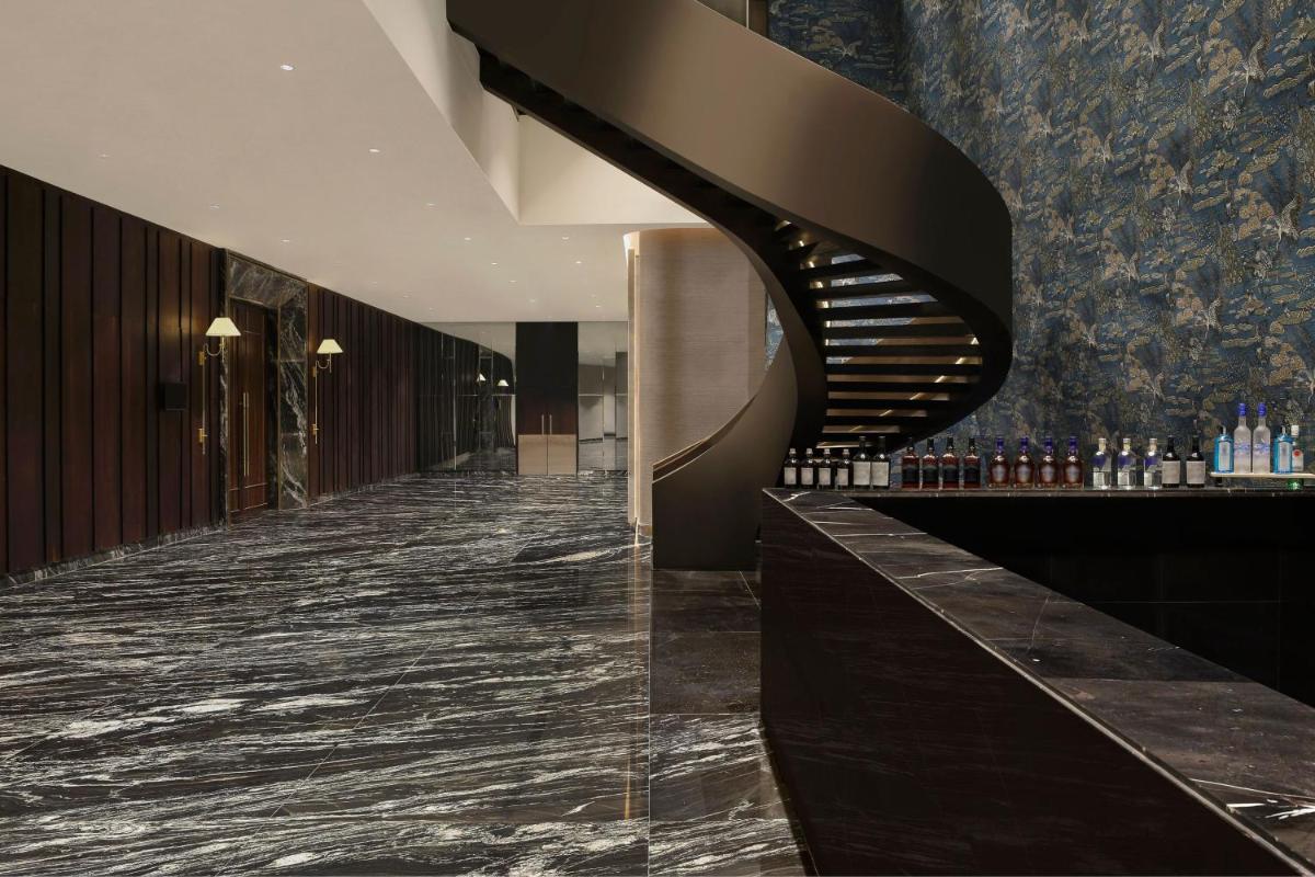 a lobby of a hotel with a spiral staircase at The Westin Pune Koregaon Park in Pune