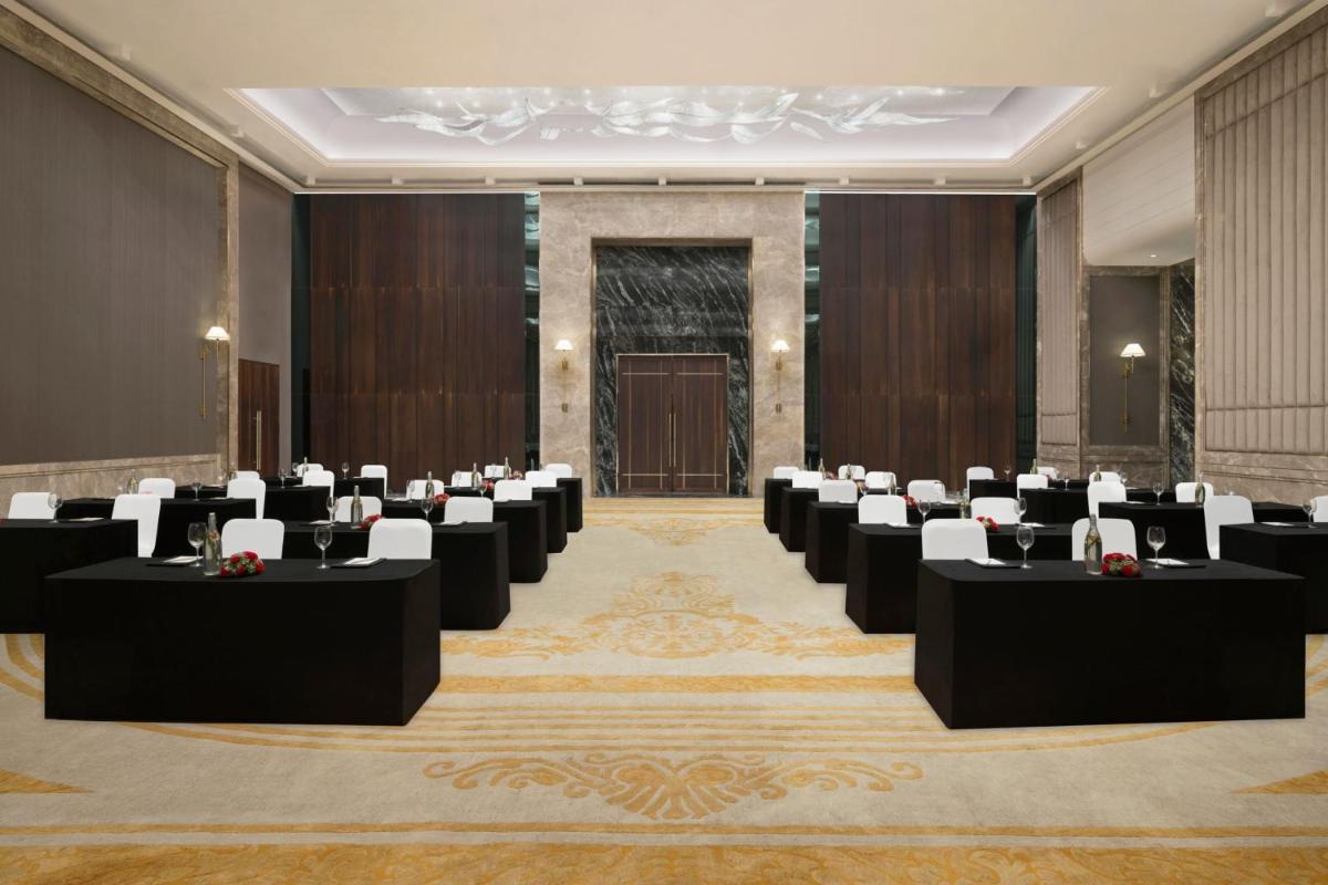 a conference room with rows of tables and chairs at The Westin Pune Koregaon Park in Pune