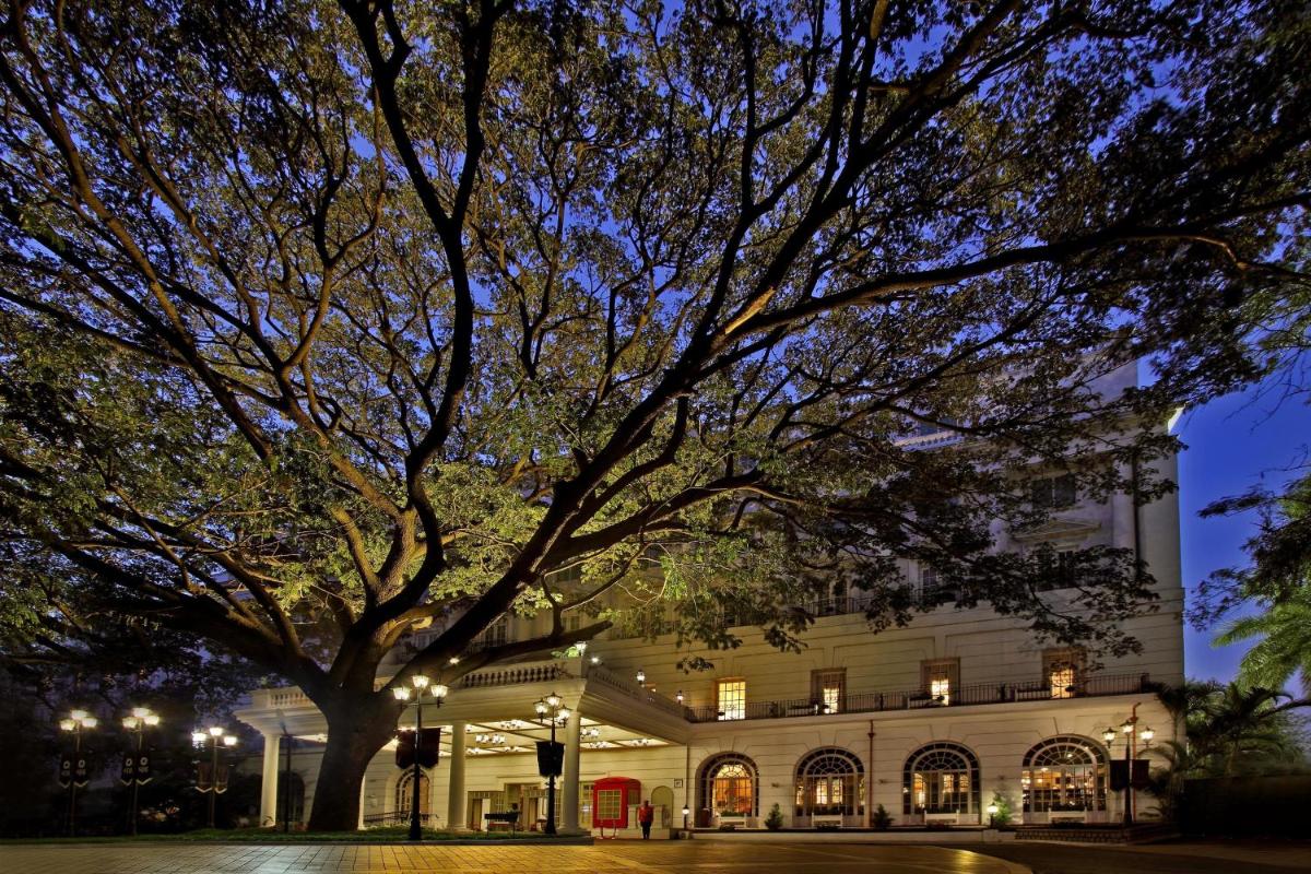 a large building with a tree in front of it at ITC Windsor, a Luxury Collection Hotel, Bengaluru in Bengaluru a large building with a tree in front of it at ITC Windsor, a Luxury Collection Hotel, Bengaluru in Bengaluru