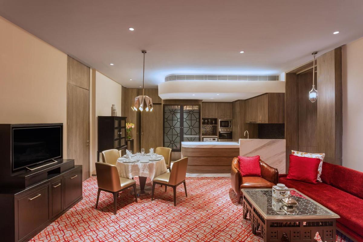 a living room with a red couch and a table at ITC Kohenur, a Luxury Collection Hotel, Hyderabad in Hyderabad