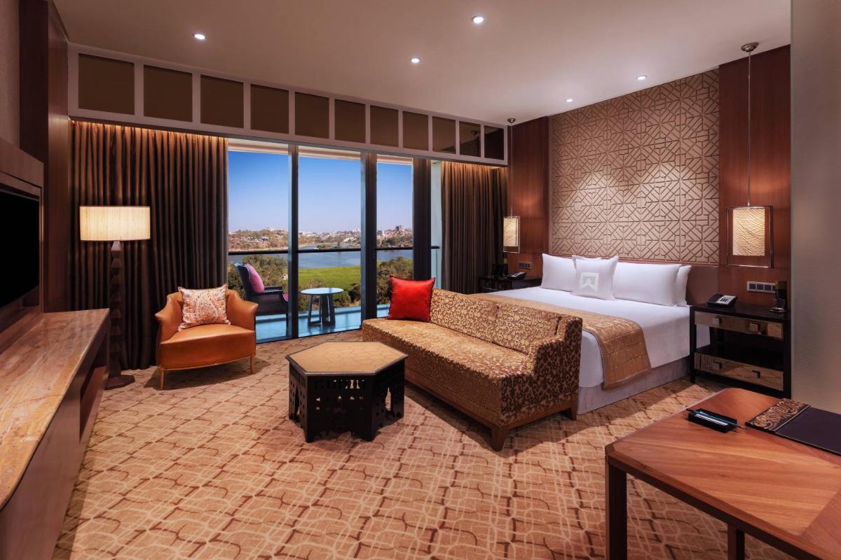 a hotel room with a bed and a couch at ITC Kohenur, a Luxury Collection Hotel, Hyderabad in Hyderabad