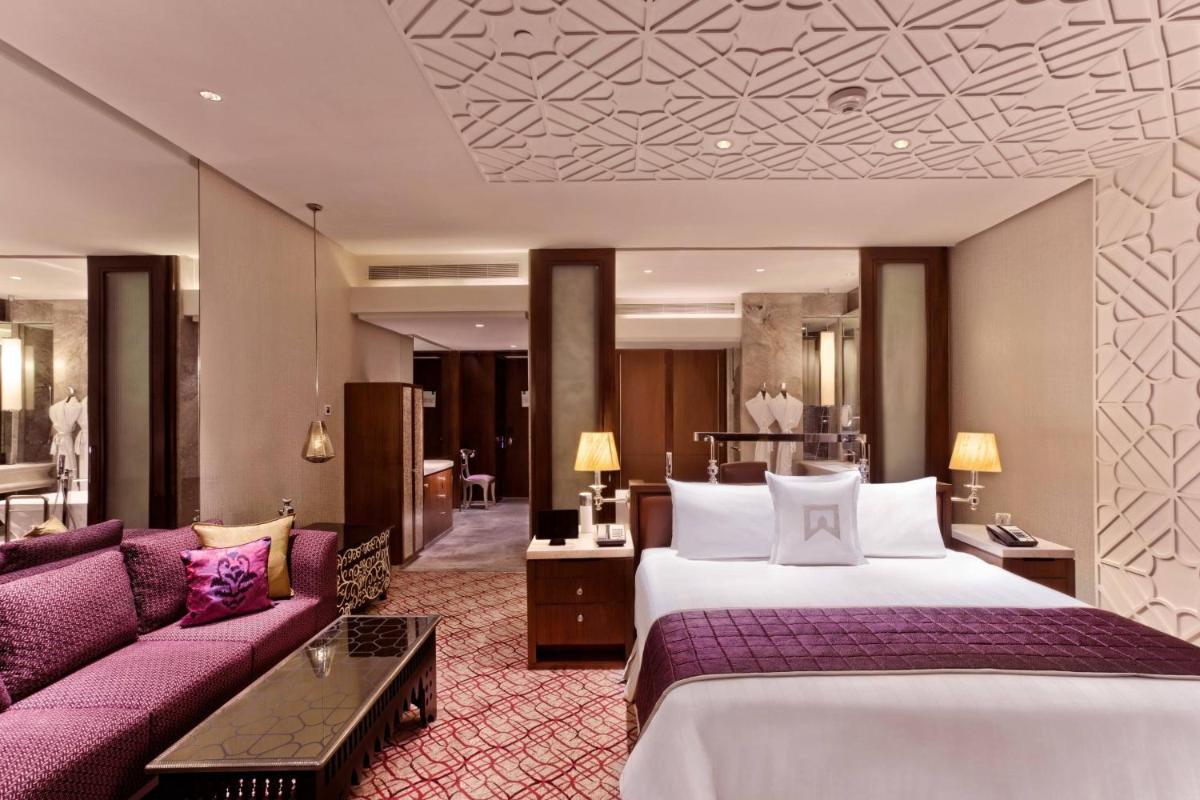 a hotel room with a bed and a couch at ITC Kohenur, a Luxury Collection Hotel, Hyderabad in Hyderabad