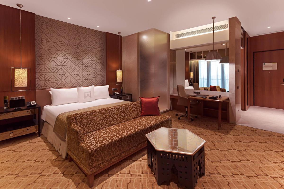 a hotel room with a bed and a couch at ITC Kohenur, a Luxury Collection Hotel, Hyderabad in Hyderabad