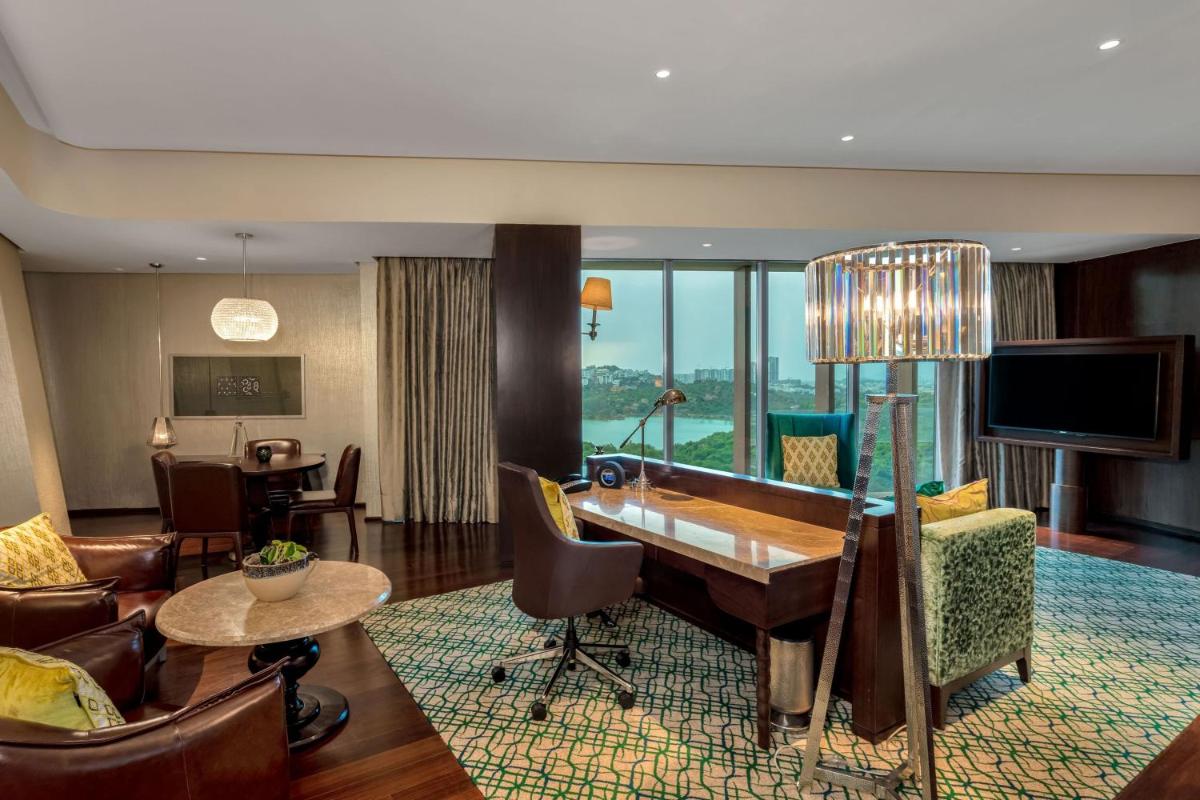 a hotel room with a piano and a living room at ITC Kohenur, a Luxury Collection Hotel, Hyderabad in Hyderabad
