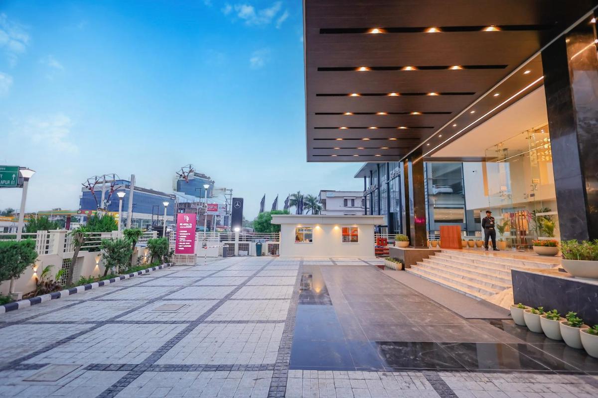 a walkway in front of a building at Regenta Dehradun by Royal Orchid Hotels Limited in Dehradun