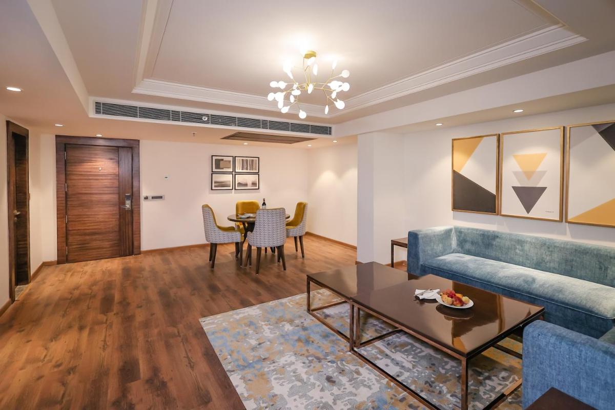 a living room with a couch and a table at Regenta Dehradun by Royal Orchid Hotels Limited in Dehradun