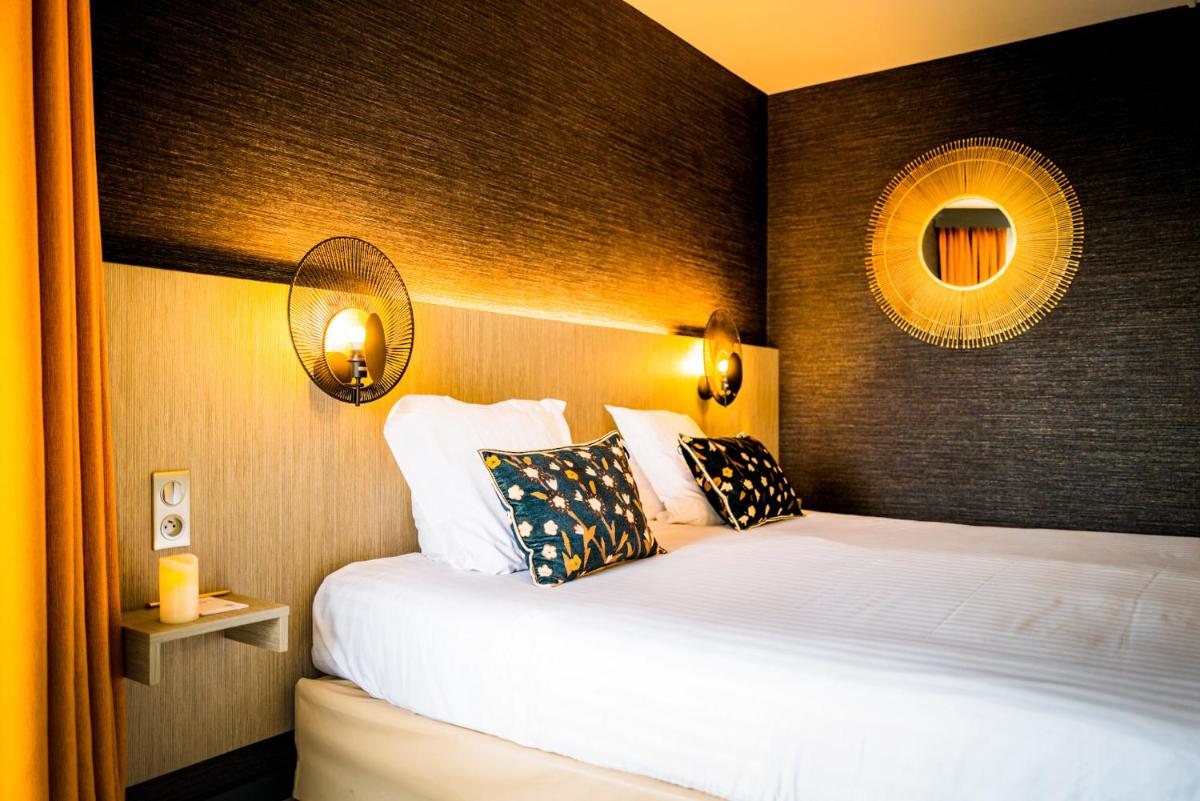 Un ou plusieurs lits dans un hébergement de l'établissement Hôtel Valdys Thalasso & Spa - les Pins