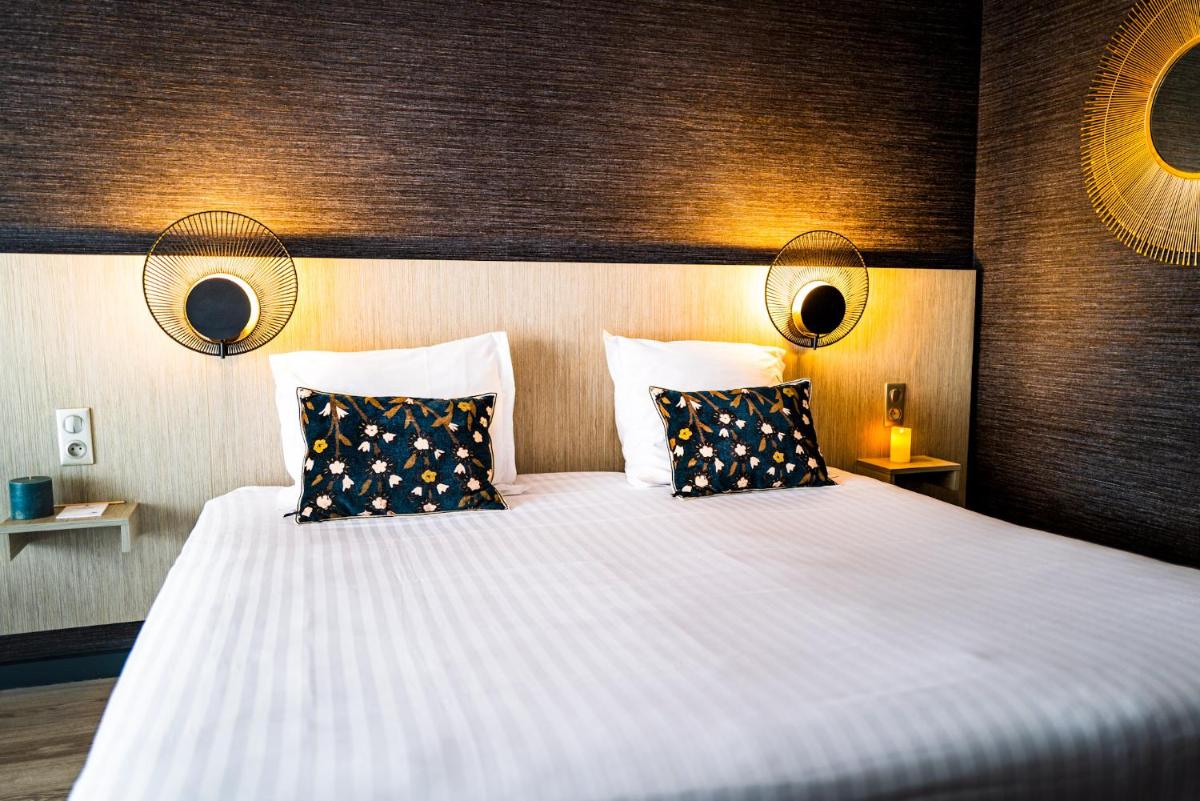 Un ou plusieurs lits dans un hébergement de l'établissement Hôtel Valdys Thalasso & Spa - les Pins