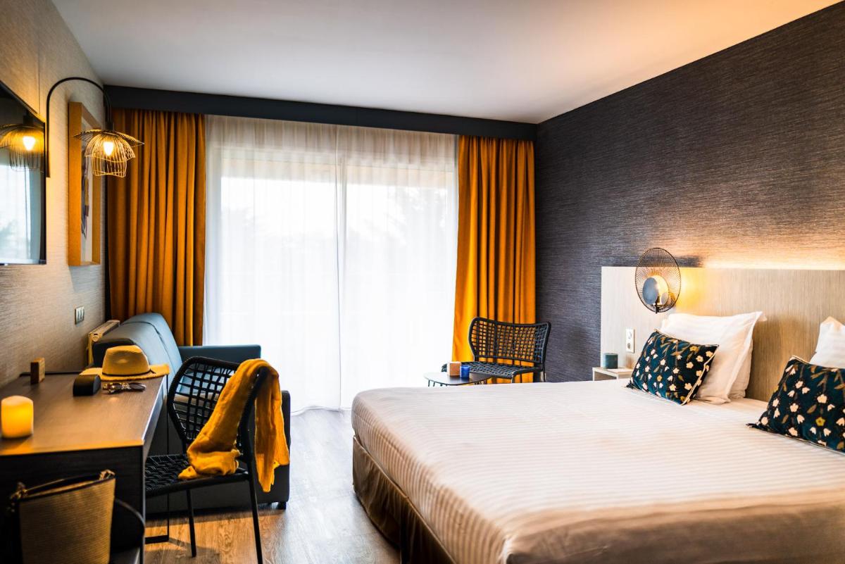 Un ou plusieurs lits dans un hébergement de l'établissement Hôtel Valdys Thalasso & Spa - les Pins
