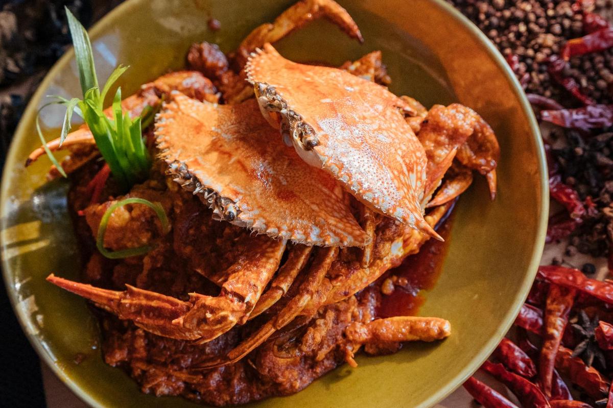 a plate of food with crabs and other foods at Hyatt Regency Lucknow Gomti Nagar in Lucknow