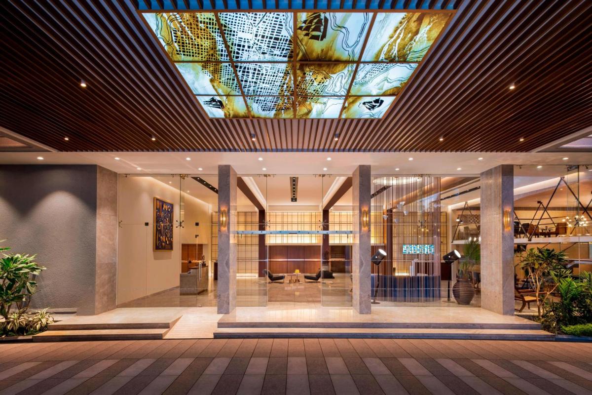 a lobby with a ceiling with a stained glass ceiling at Le Meridien Goa, Calangute in Calangute a lobby with a ceiling with a stained glass ceiling at Le Meridien Goa, Calangute in Calangute