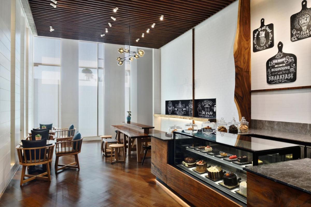 a kitchen and dining room with a table and chairs at The Westin Mumbai Powai Lake in Mumbai