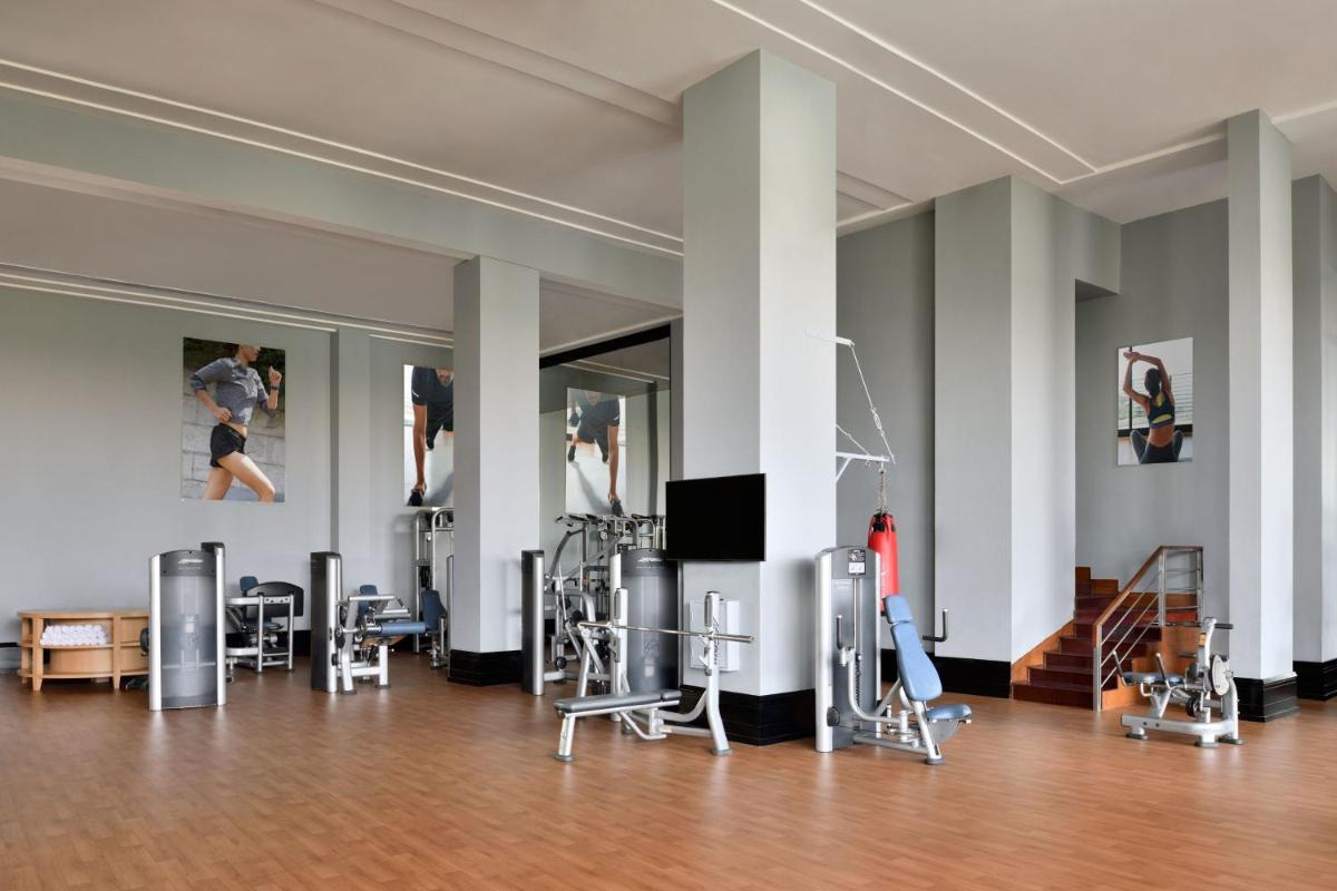 a room with chairs and paintings on the walls at The Westin Mumbai Powai Lake in Mumbai