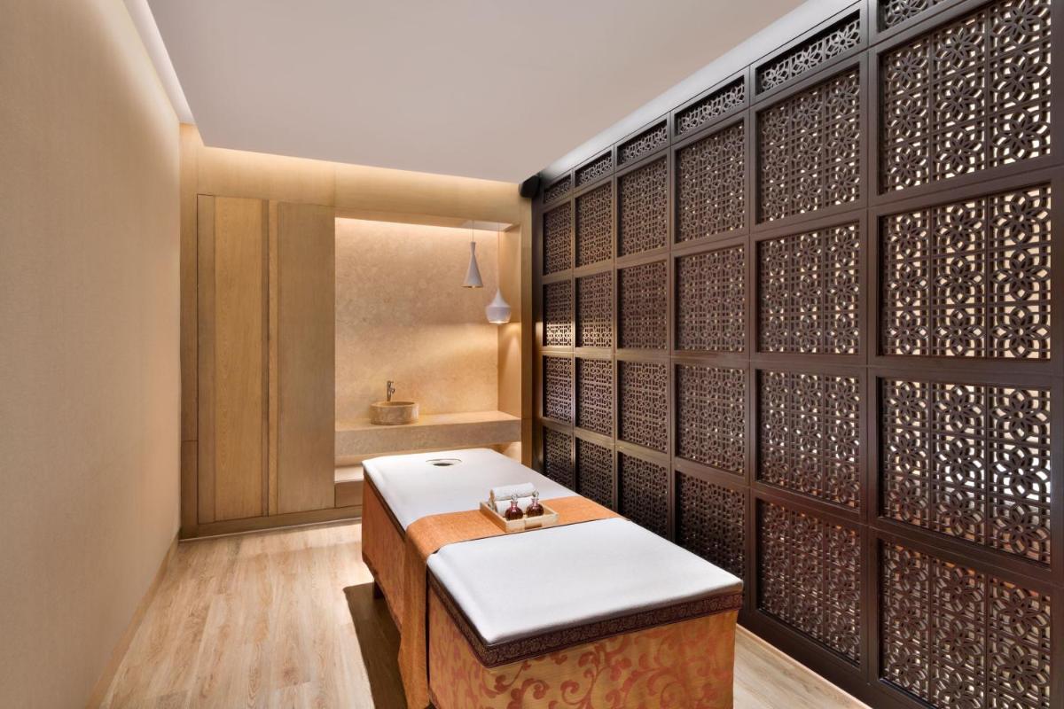 a meditation room with a bench and a wall of wine bottles at The Westin Mumbai Powai Lake in Mumbai