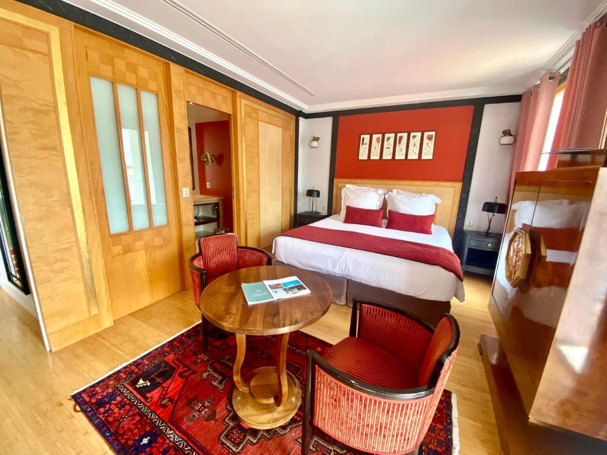 Un ou plusieurs lits dans un hébergement de l'établissement HR Hôtel-Restaurant & Spa Marin