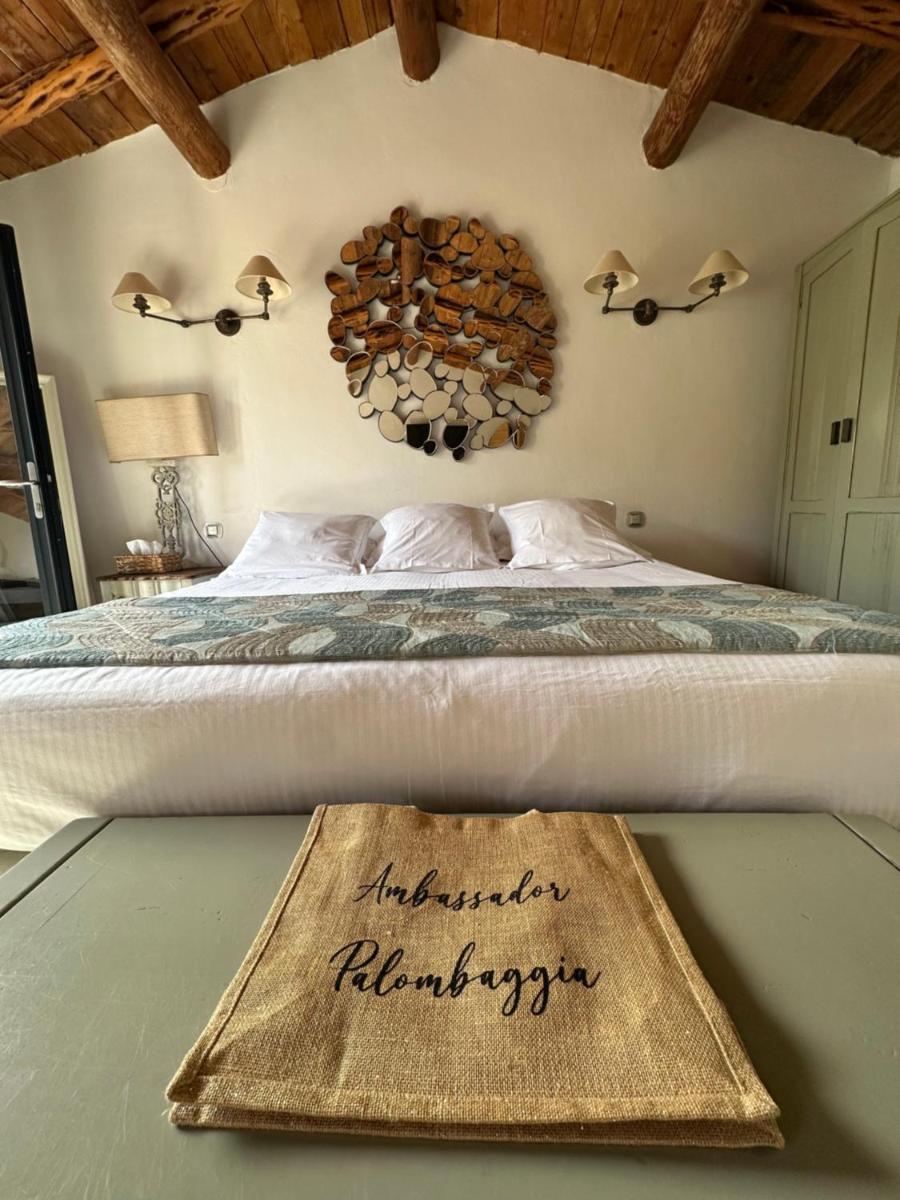 Un ou plusieurs lits dans un hébergement de l'établissement Hôtel Ambassador Palombaggia