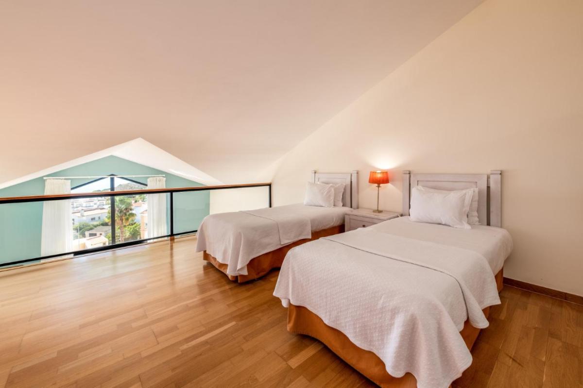 Uma cama ou camas num quarto em Estrela da Luz Resort