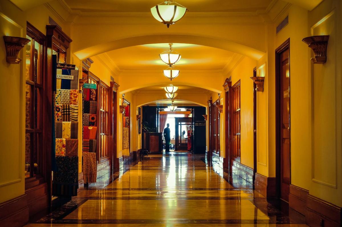 a hallway in a building with an archway and lights at Eros Hotel New Delhi, Nehru Place in New Delhi a hallway in a building with an archway and lights at Eros Hotel New Delhi, Nehru Place in New Delhi