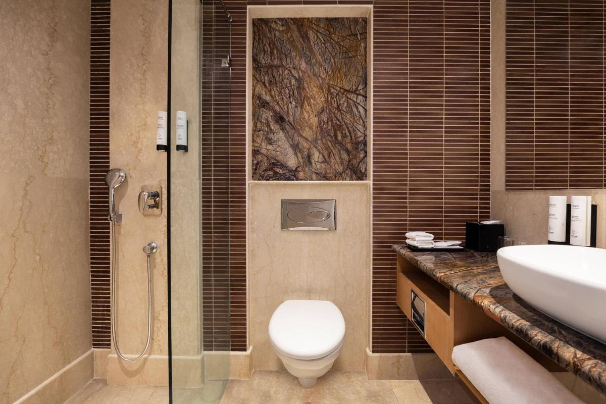 a bathroom with a toilet and a sink and a shower at Fairfield by Marriott Jaipur in Jaipur +21 photos