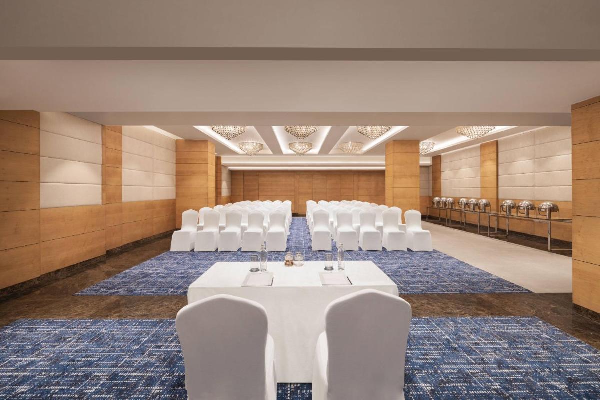 a conference room with white chairs and a table in the middle at Fairfield by Marriott Jaipur in Jaipur