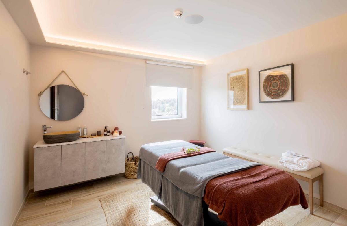Uma cama ou camas num quarto em Sleep & Nature Hotel