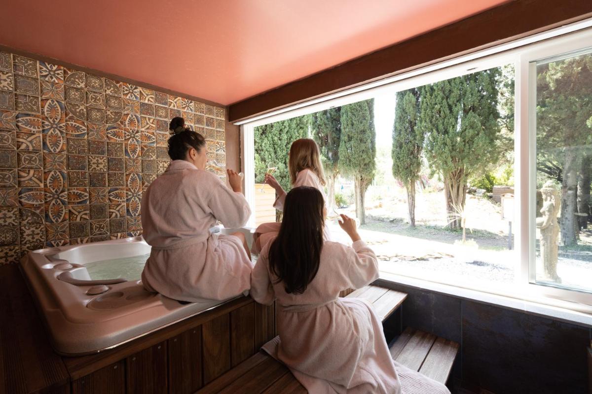 - un groupe de personnes dans une baignoire donnant sur la fenêtre dans l'établissement La Villa Vicha, The Originals Relais, à Aubais