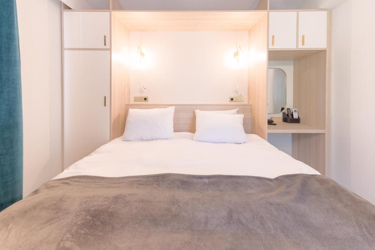 Un ou plusieurs lits dans un hébergement de l'établissement La Villa Vicha, The Originals Relais