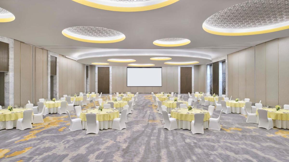 a banquet hall with white tables and white chairs at The Westin Resort & Spa Himalayas in Rishīkesh