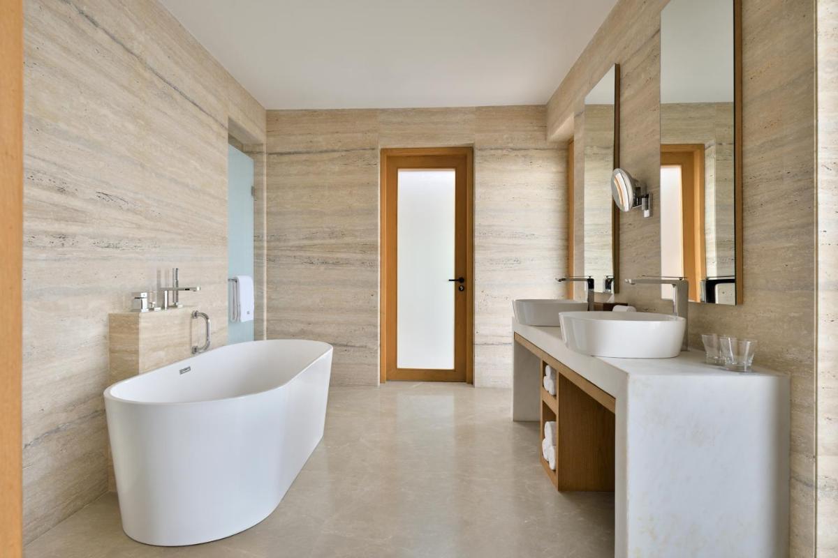 a bathroom with two sinks and a large white tub at The Westin Resort & Spa Himalayas in Rishīkesh