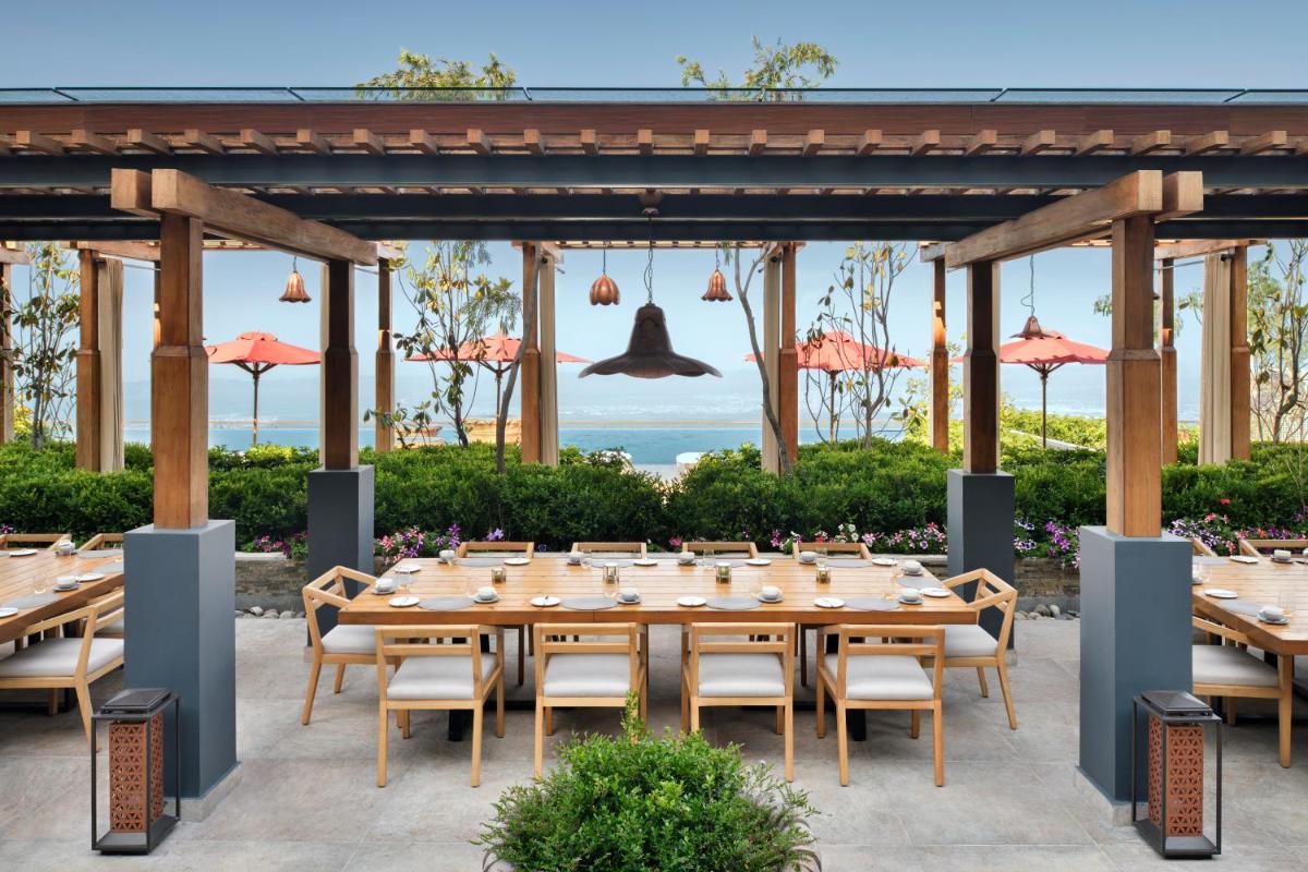 a dining area with wooden tables and chairs at The Westin Resort & Spa Himalayas in Rishīkesh