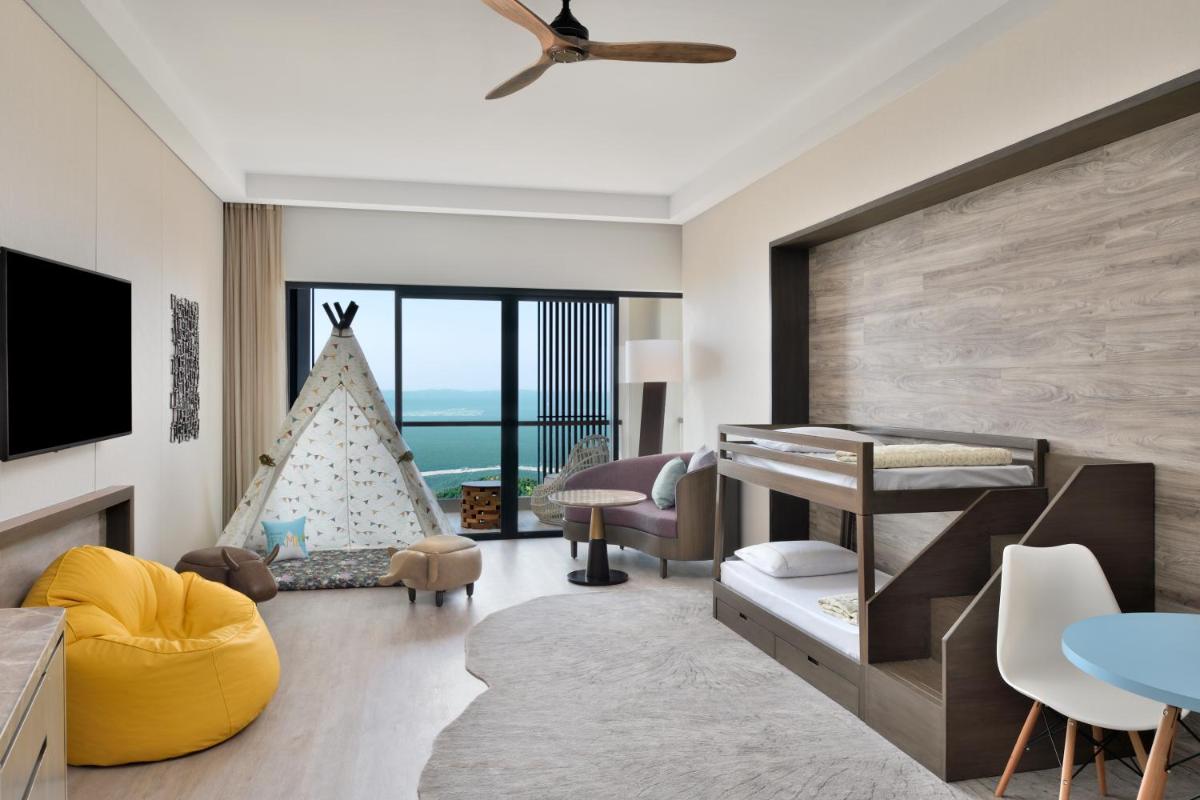 a bedroom with a bed and a play area with a play tent at The Westin Resort & Spa Himalayas in Rishīkesh