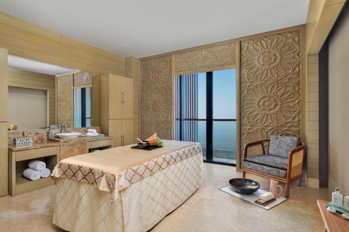 a bathroom with a table and a chair in a room at The Westin Resort & Spa Himalayas in Rishīkesh