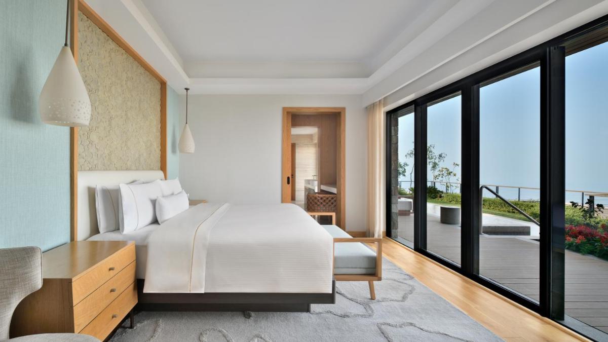 a bedroom with a bed and a balcony at The Westin Resort & Spa Himalayas in Rishīkesh