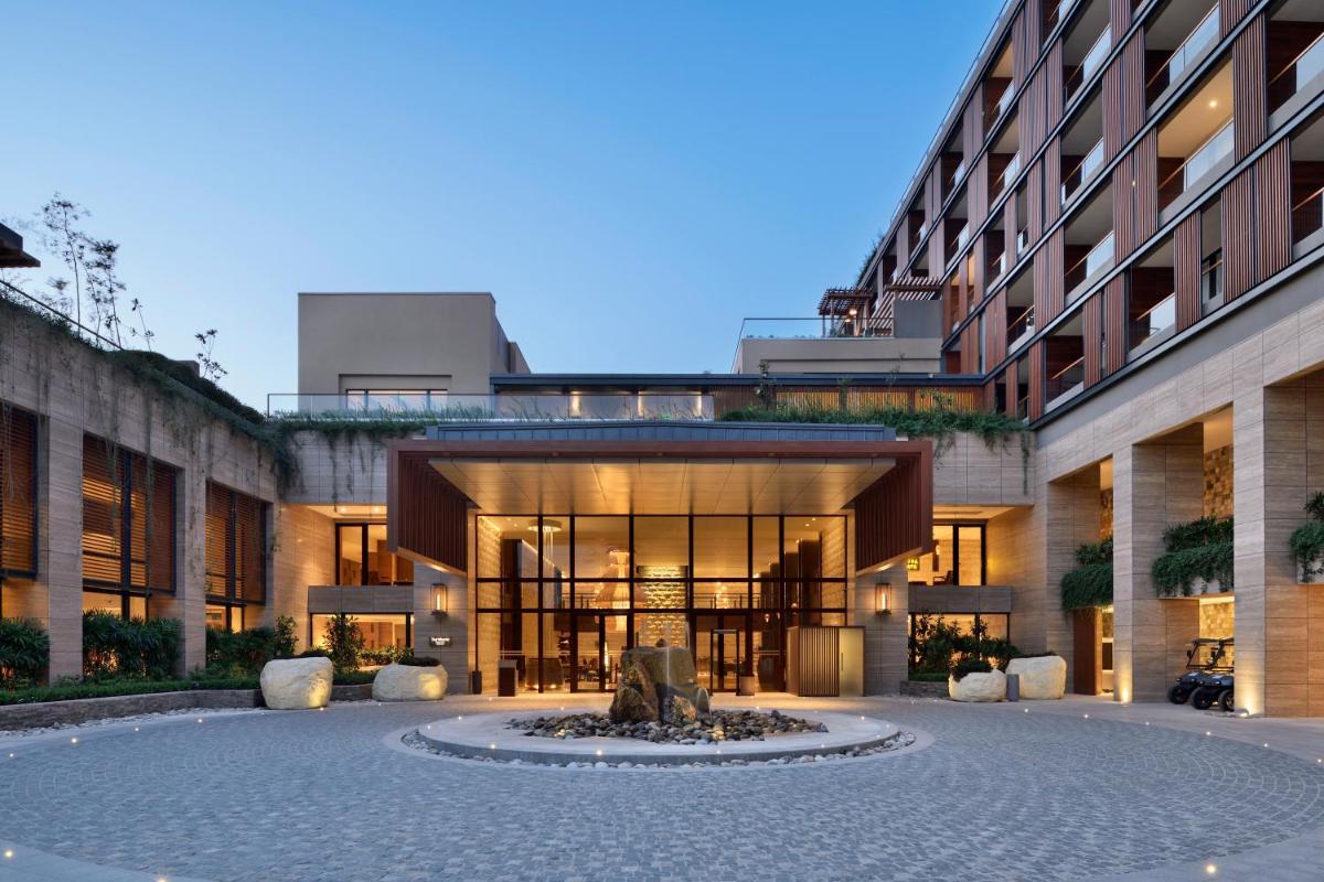 a building with a fountain in the middle of a courtyard at The Westin Resort & Spa Himalayas in Rishīkesh
