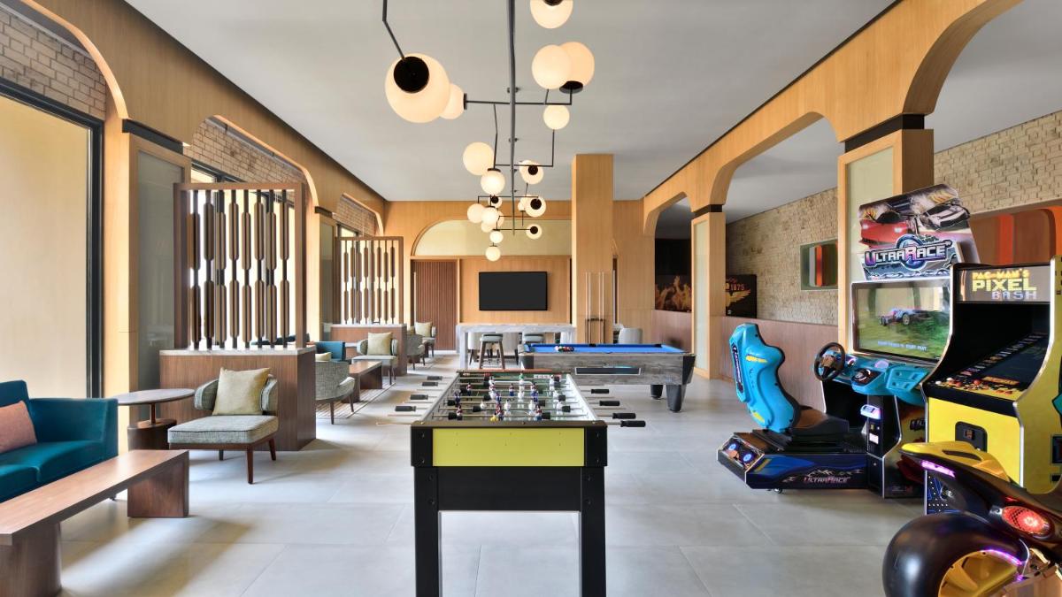 a room with arcade games and a pool table at The Westin Resort & Spa Himalayas in Rishīkesh
