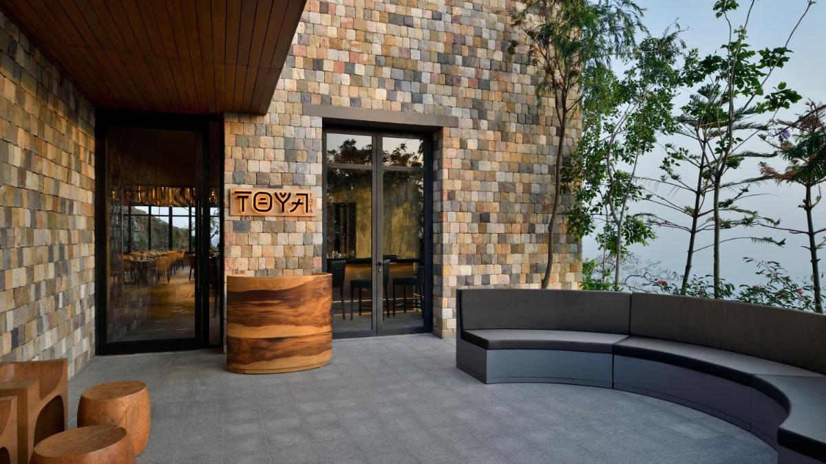 a patio with a couch and a building at The Westin Resort & Spa Himalayas in Rishīkesh