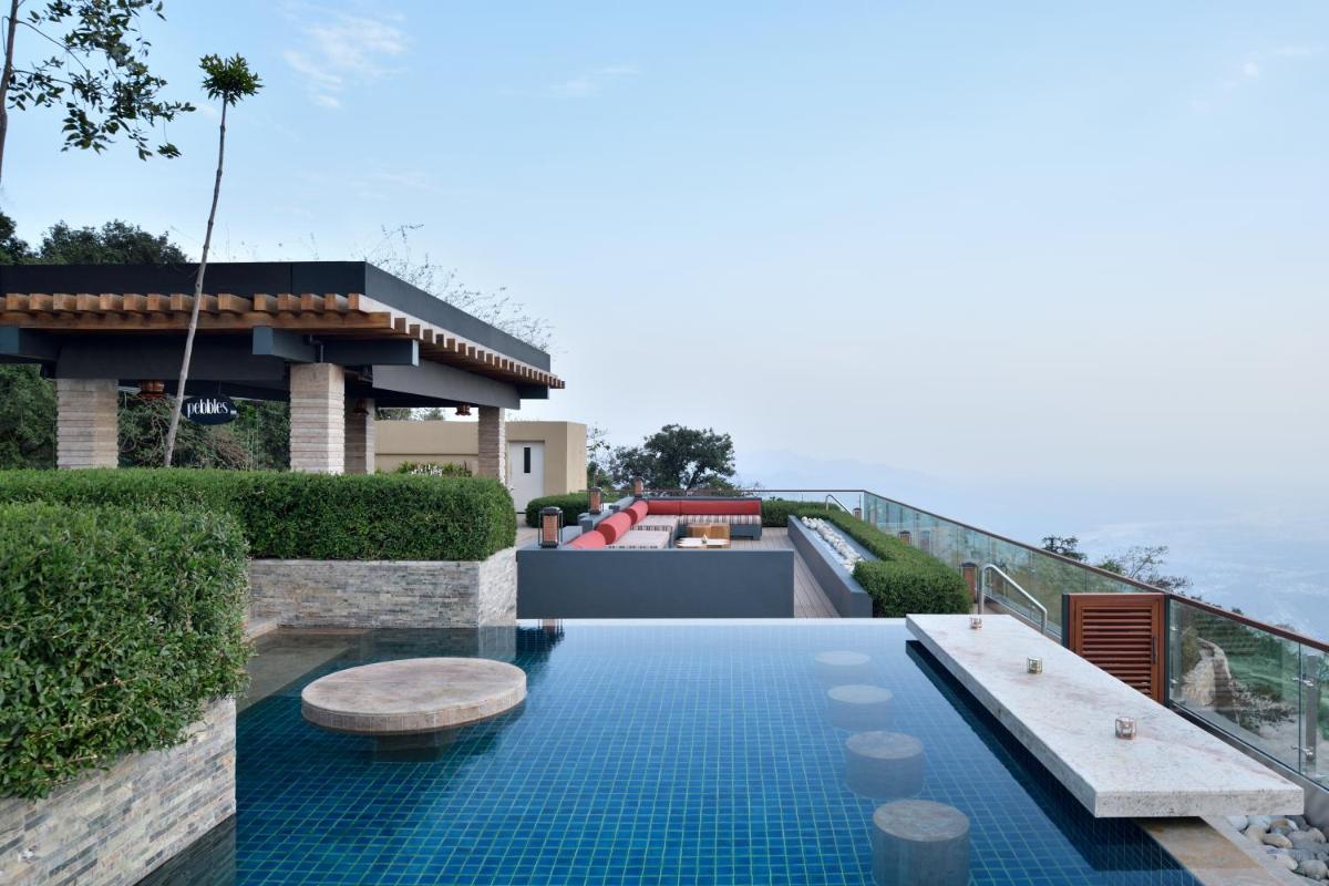 a swimming pool with a bench on top of a house at The Westin Resort & Spa Himalayas in Rishīkesh