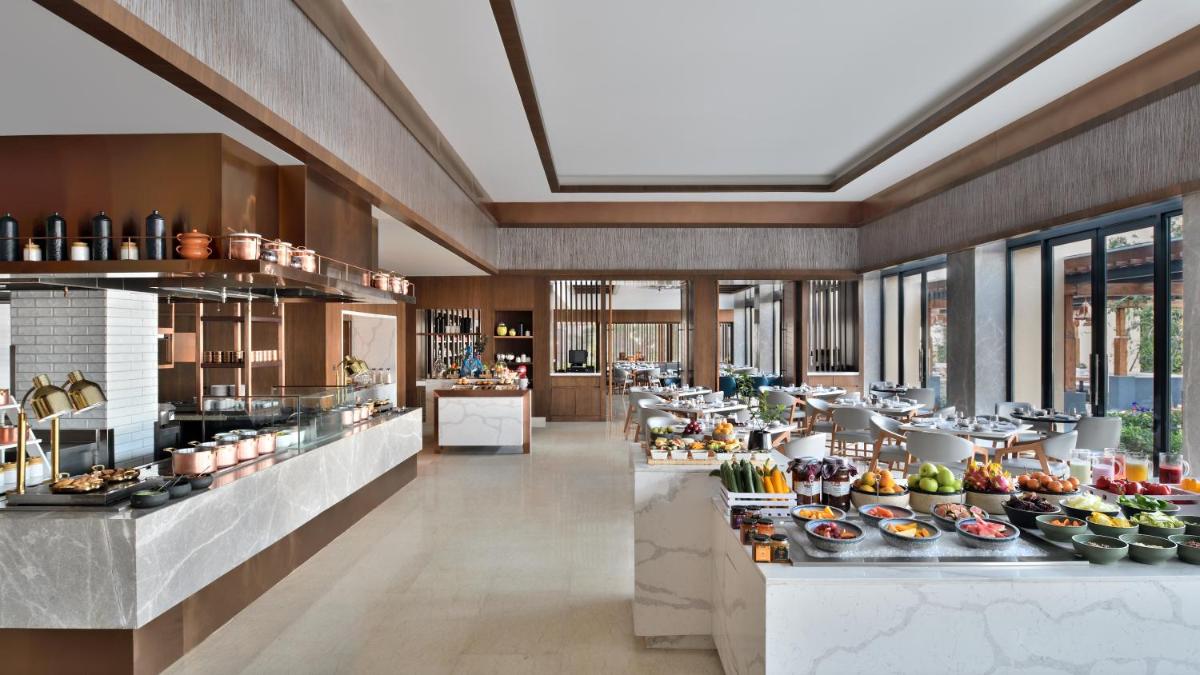 a restaurant with a buffet of food on display at The Westin Resort & Spa Himalayas in Rishīkesh