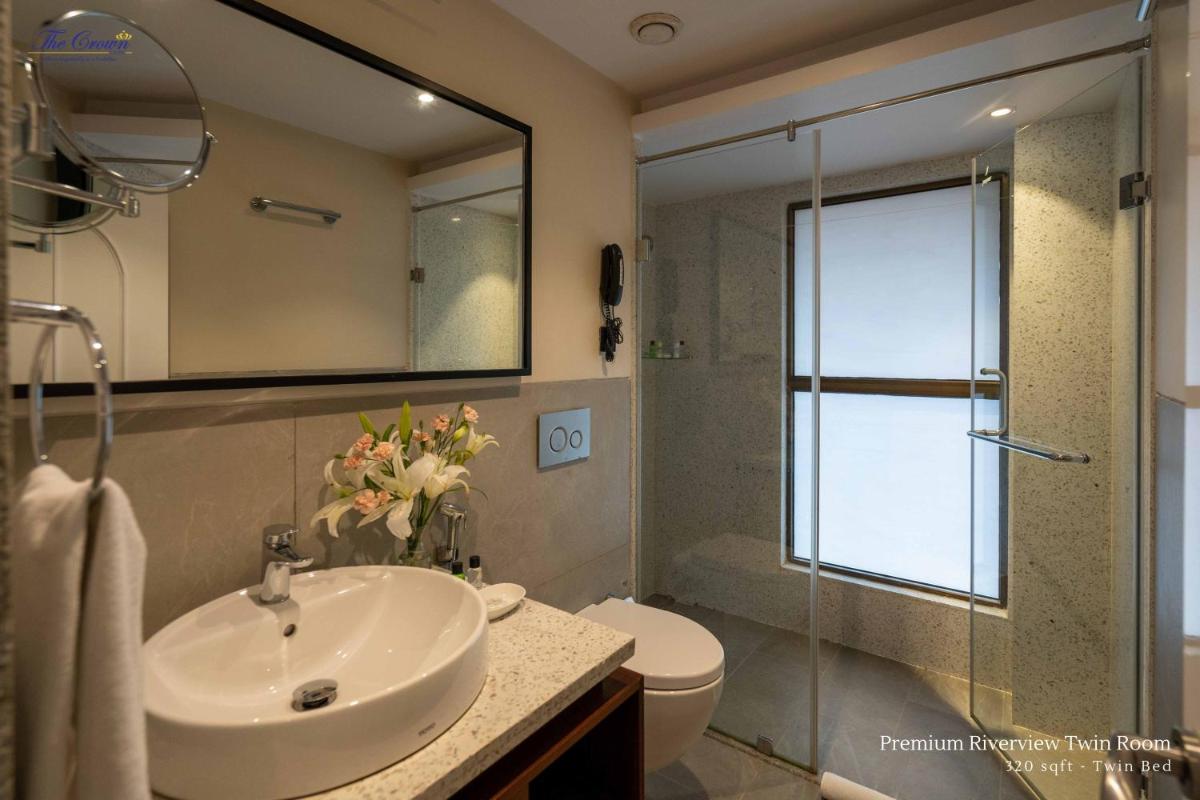 a bathroom with a sink and a toilet and a shower at The Crown Goa in Panaji