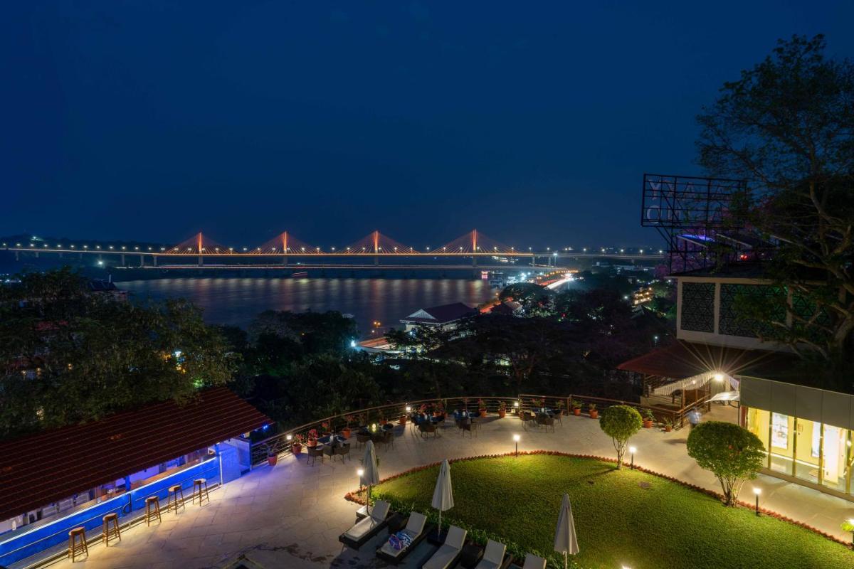 a view of a bridge over the water at night at The Crown Goa in Panaji