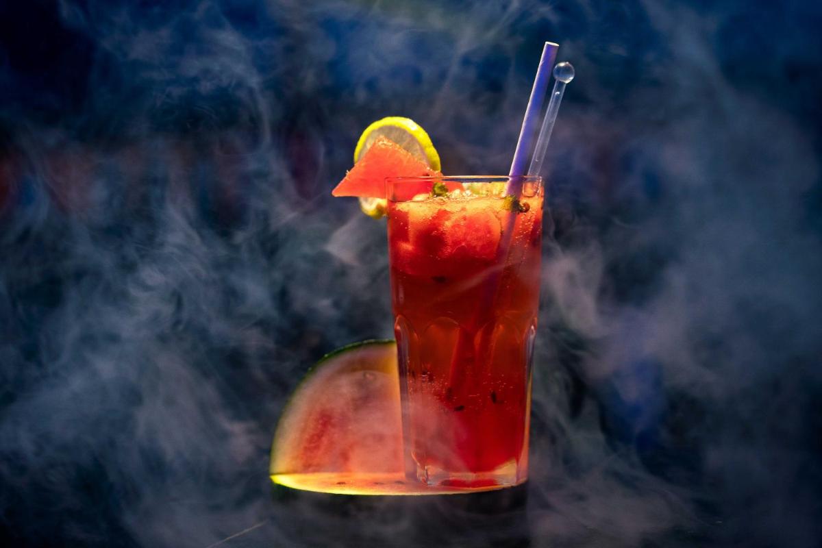 a drink in a glass with a slice of fruit at The Crown Goa in Panaji