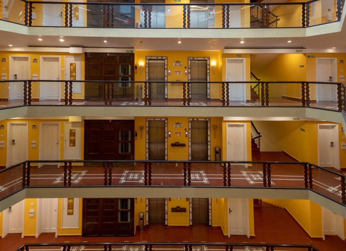 a view of a hallway of a building with doors at The Crown Goa in Panaji