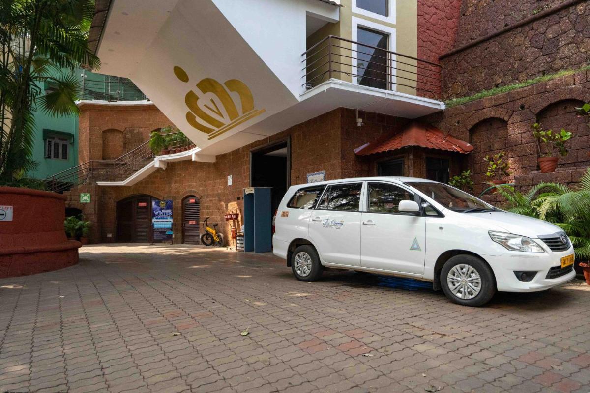 a small white car parked in front of a building at The Crown Goa in Panaji