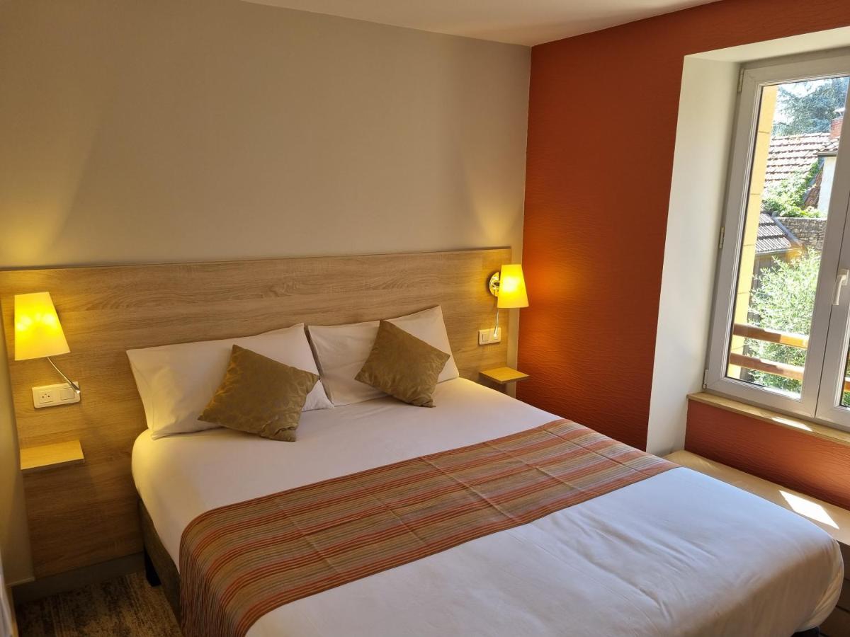 Un ou plusieurs lits dans un hébergement de l'établissement Logis Hotel Archambeau