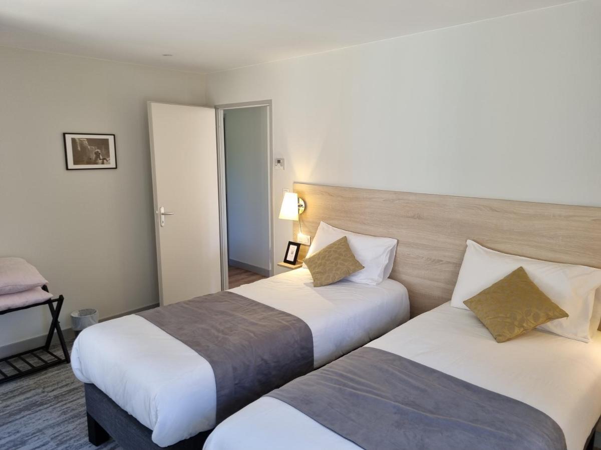 Un ou plusieurs lits dans un hébergement de l'établissement Logis Hotel Archambeau