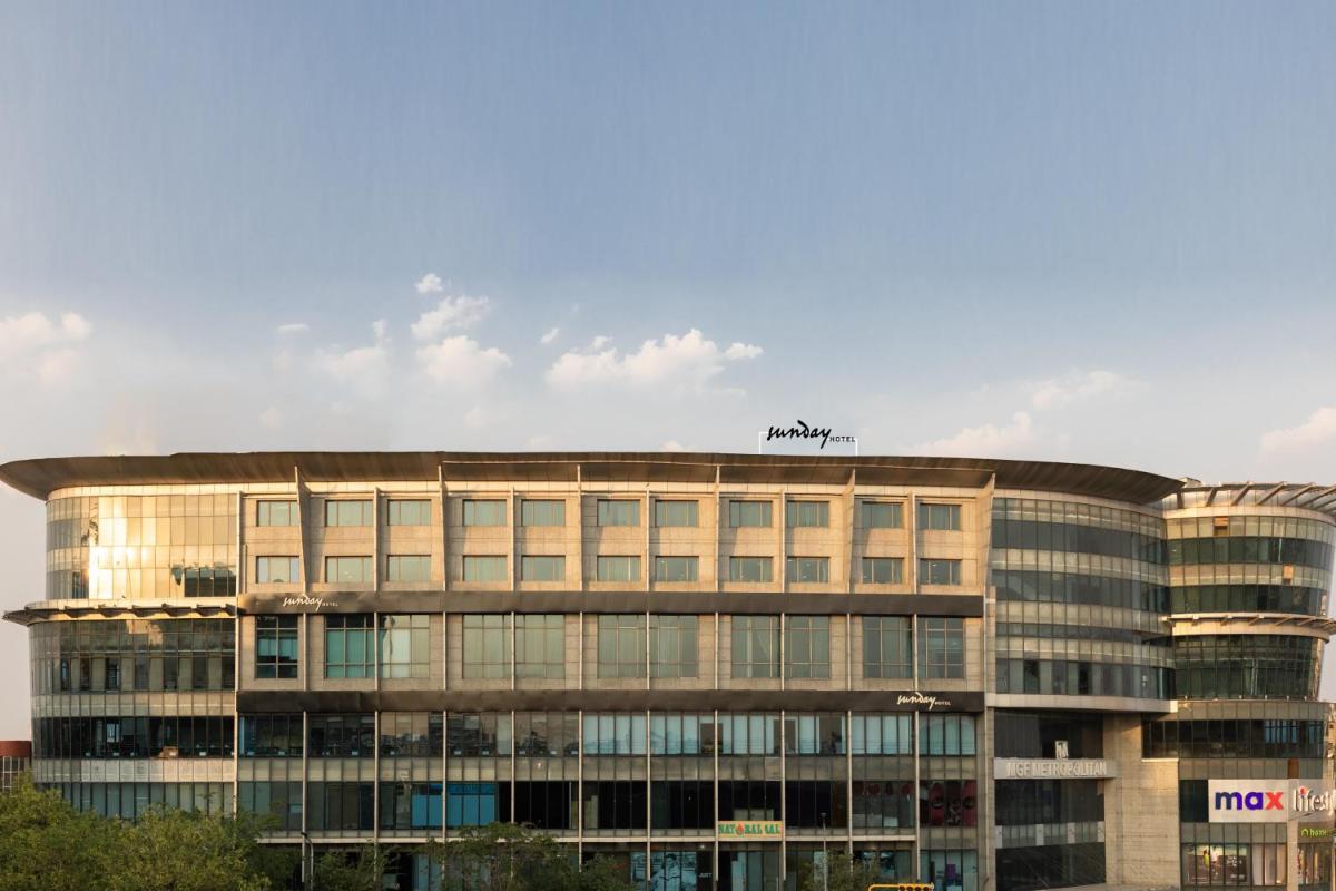 a building with a sign on the top of it at Sunday Hotel Jaipur in Jaipur