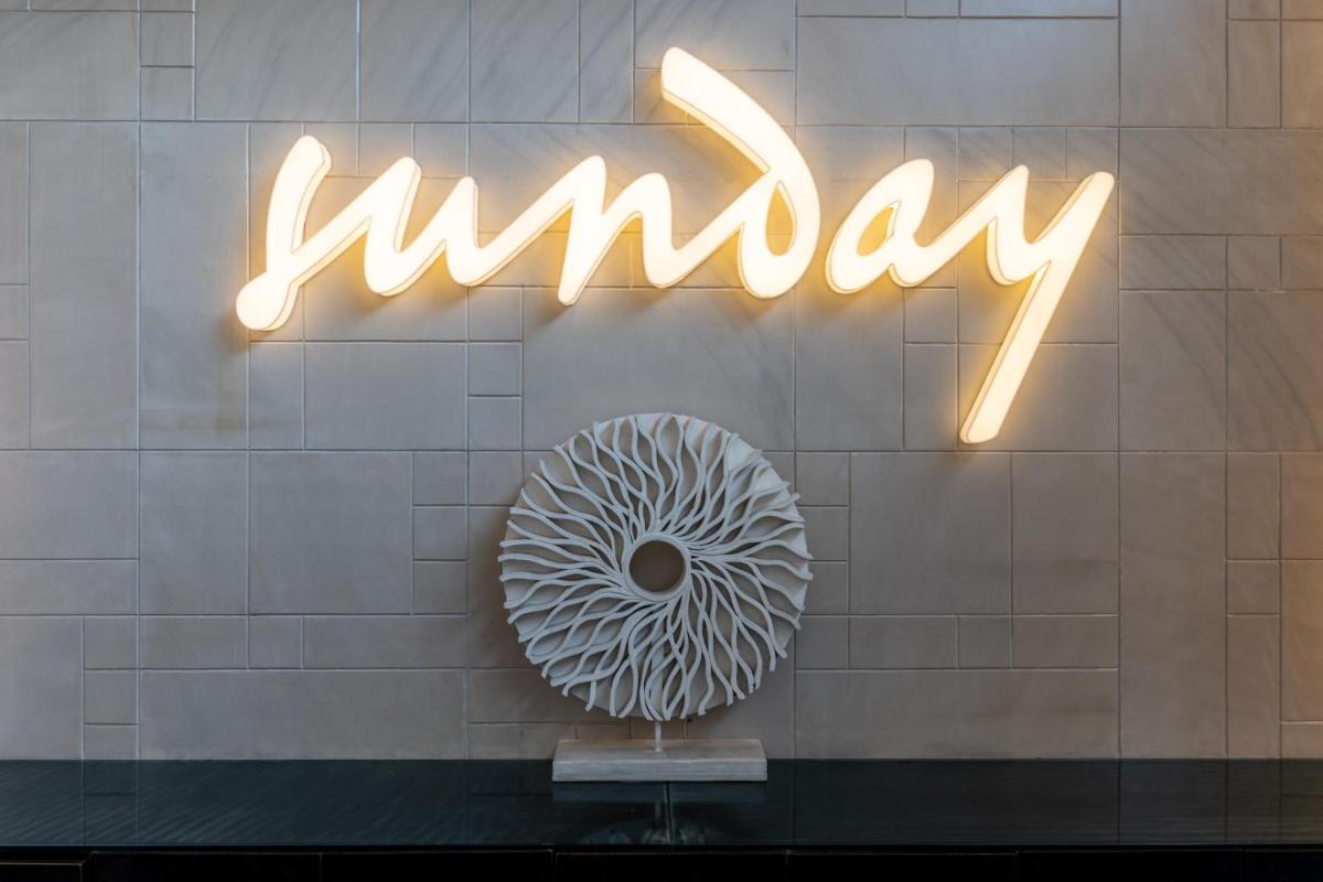 a window with a sign with a doughnut on it at Sunday Hotel Jaipur in Jaipur